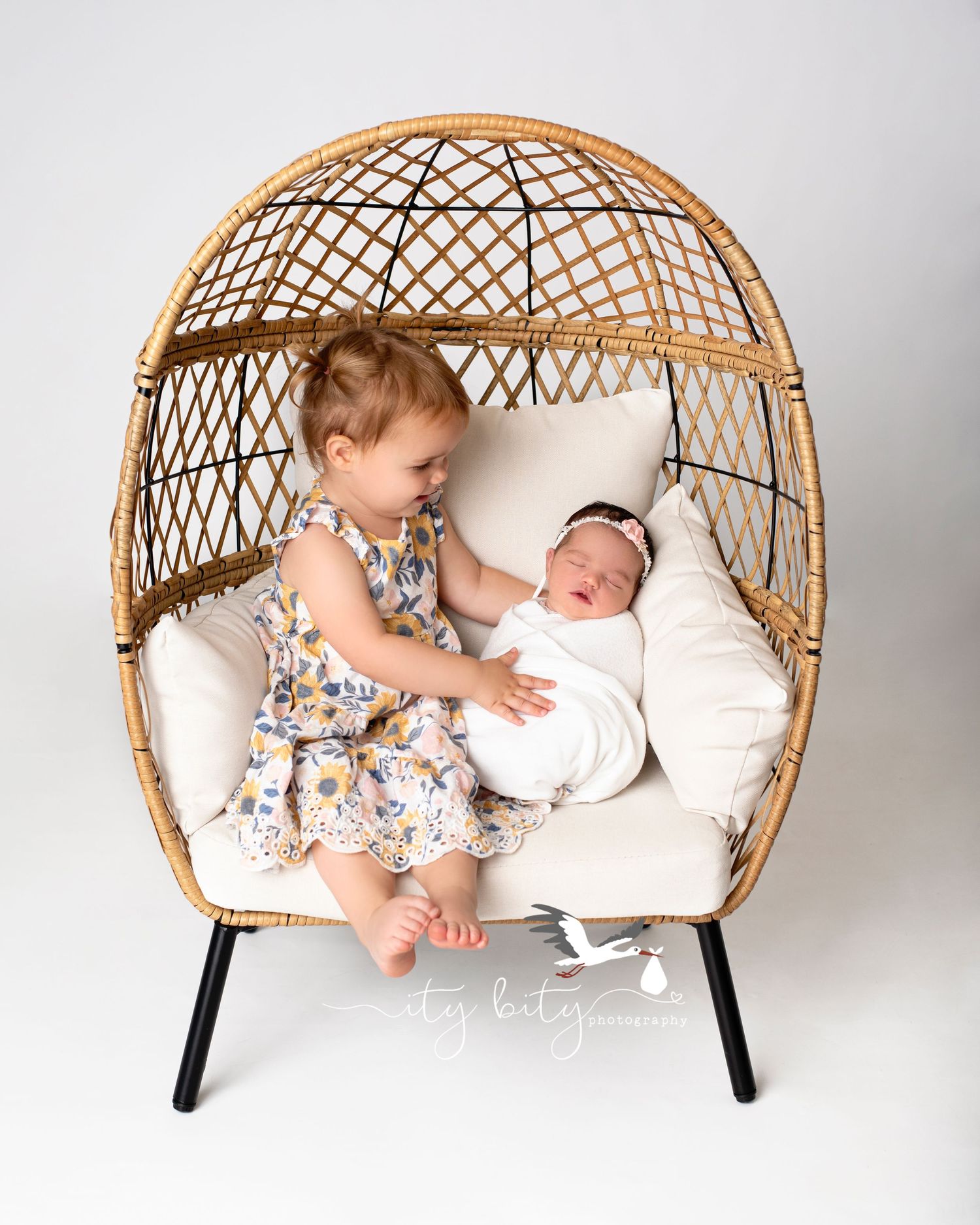 Big Sister Olivia looking at her new baby sis Grace and smiling Ity Bity Photography Avon