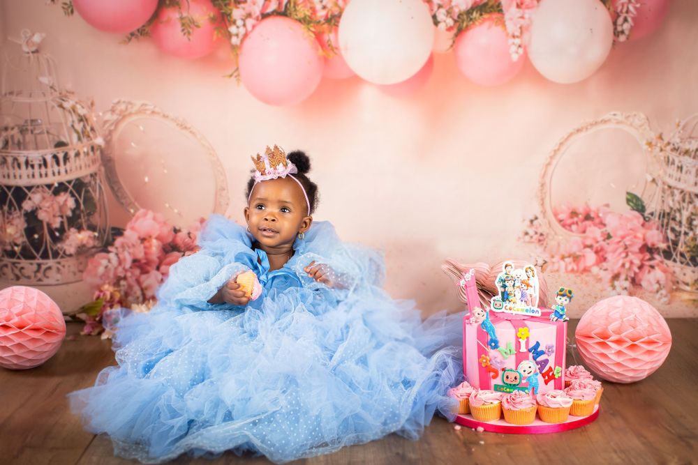 Little girl in big blue dress with cake