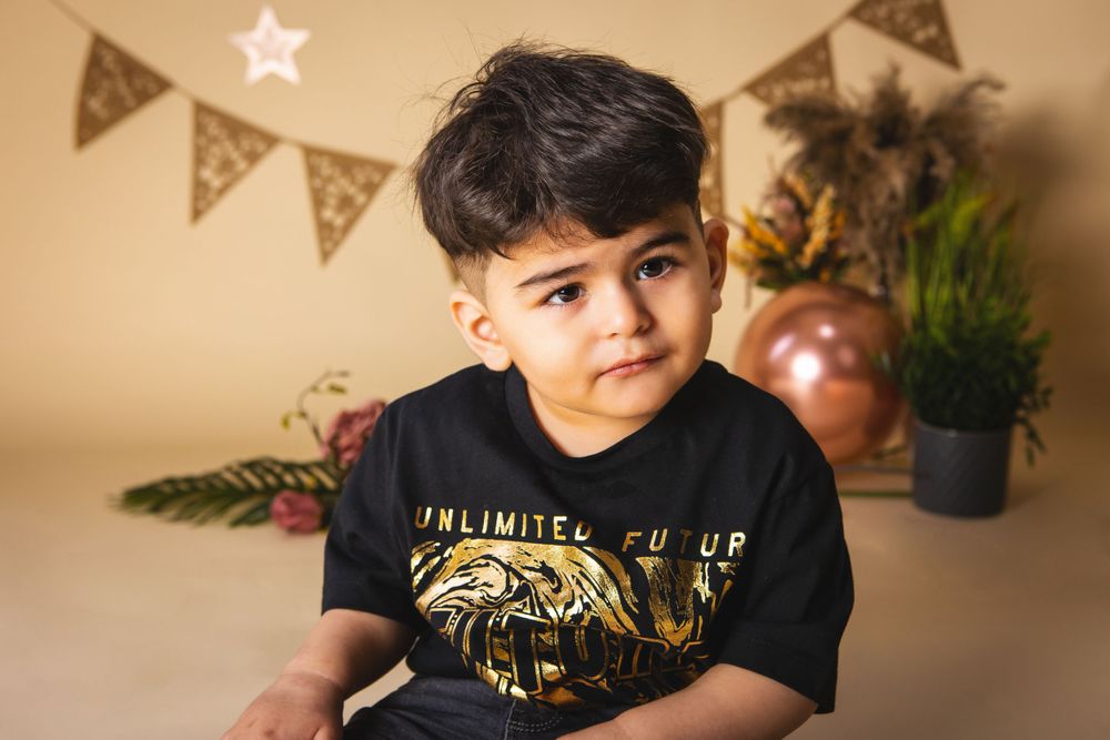 little boy with birthday decorations