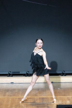 Dramatic dance performance sequence on dark stage showing flowing movements.