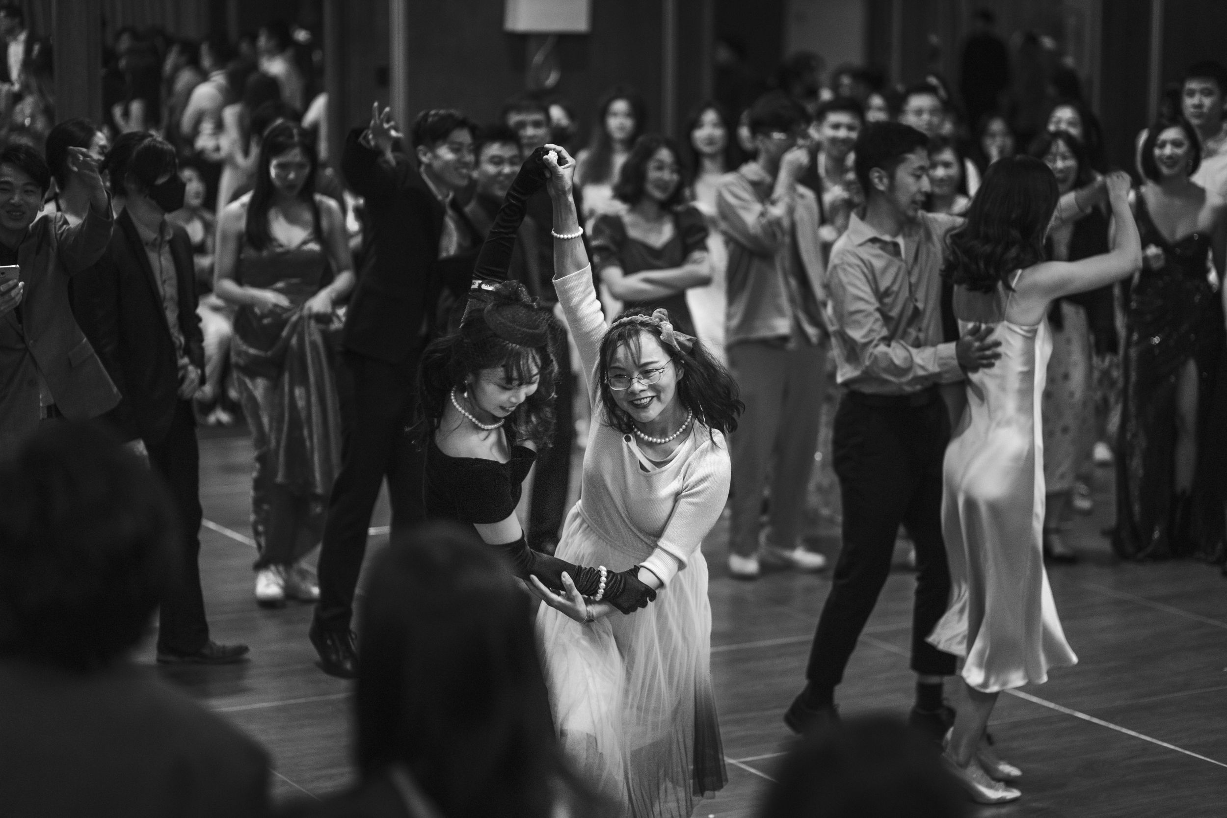 Couples fill a large dance floor during a social dancing event.