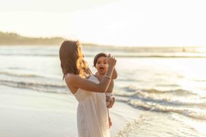 Tender family moment at sunset on the beach.