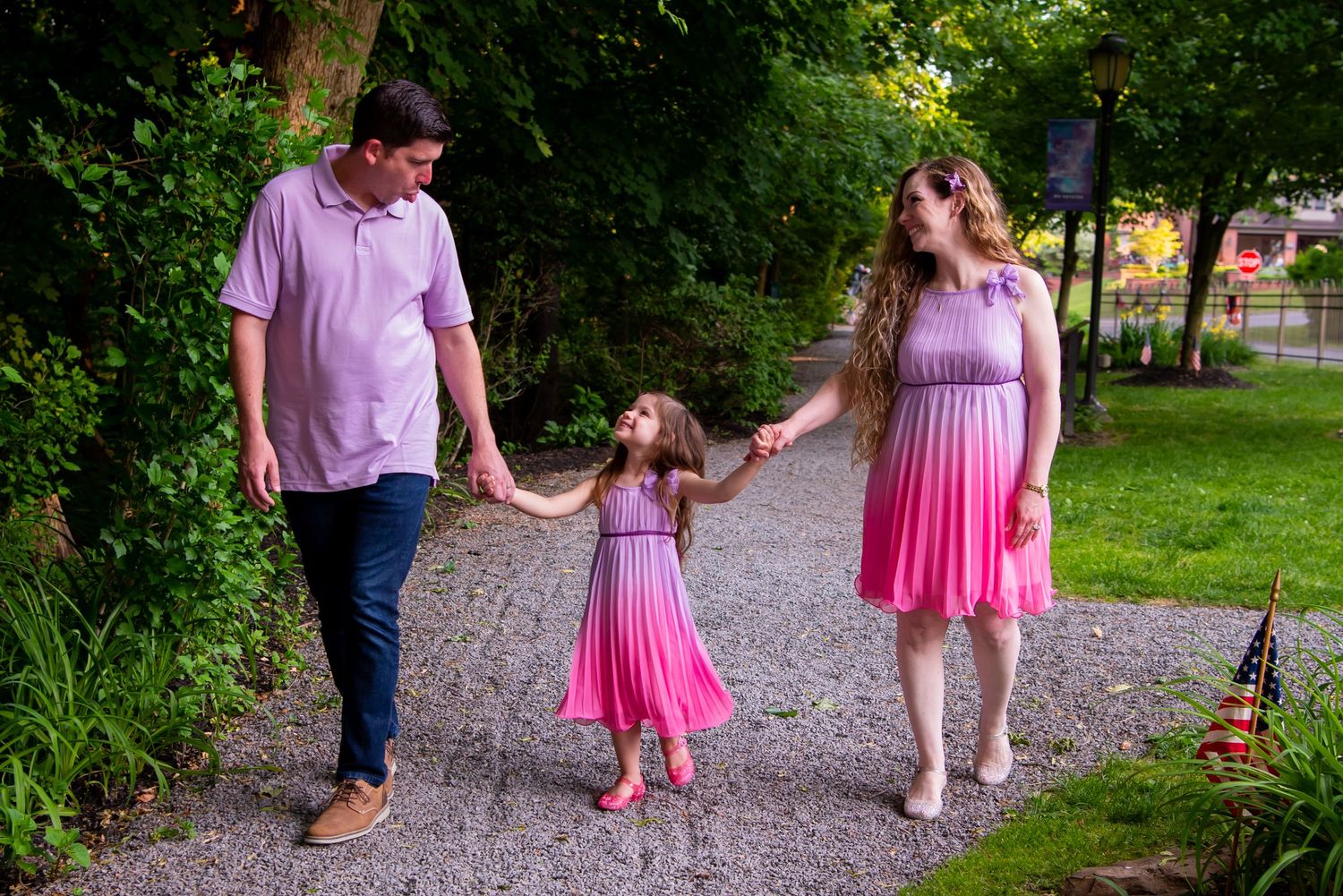 family walking toward camera, girl looking at dad