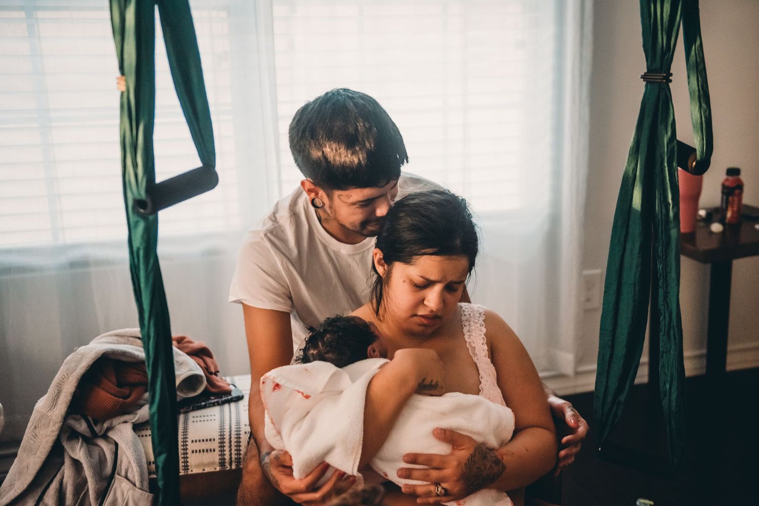 A tender family moment captured while cradling a newborn baby.