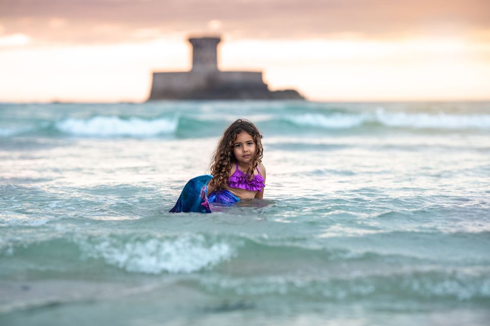 Jersey CI photographer little mermaid came out of the sea in front of La Rocco tower