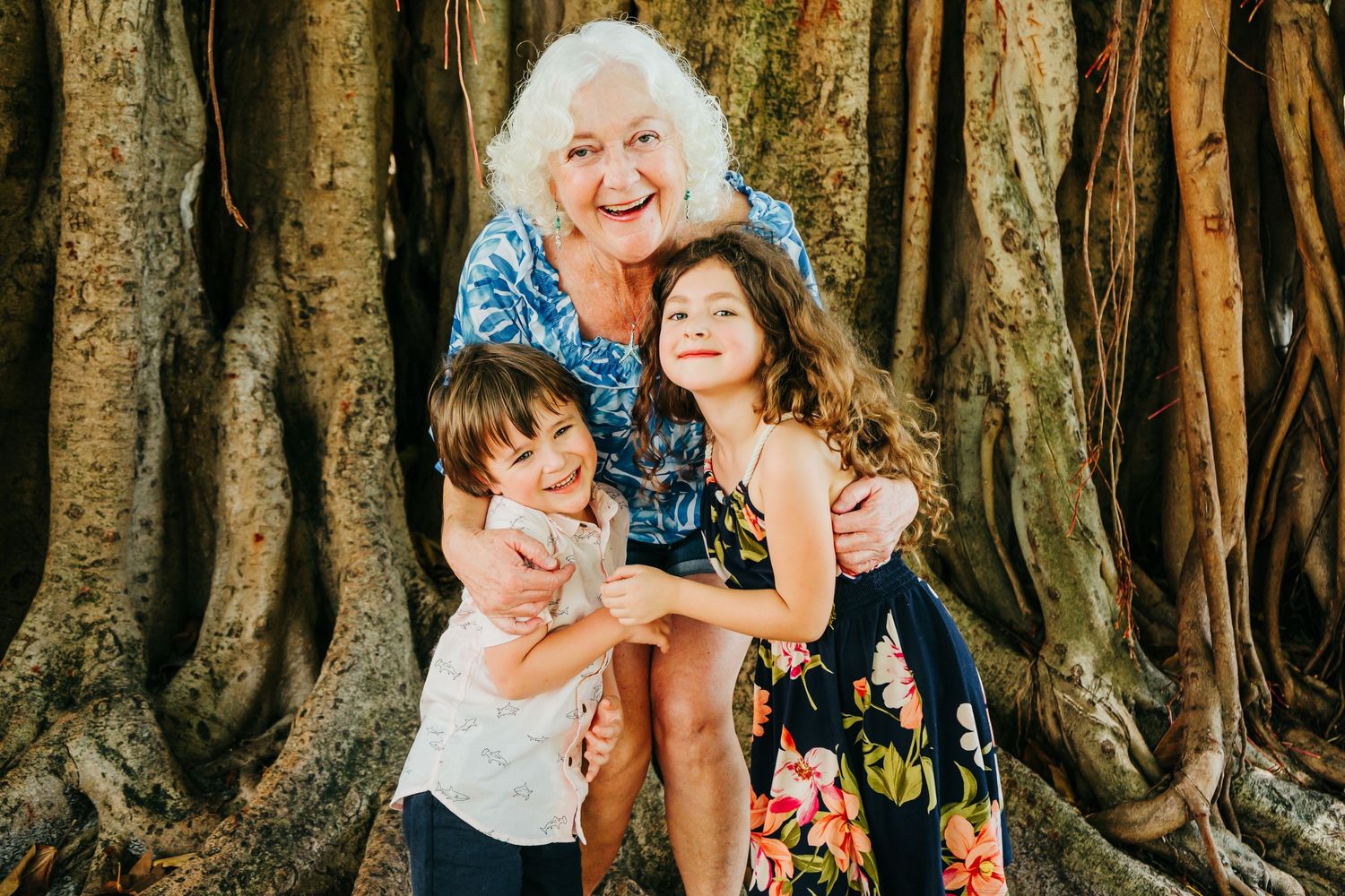 Outdoor Family Session in St. Pete, FL; Grandmother posing with grandkids near banyan trees