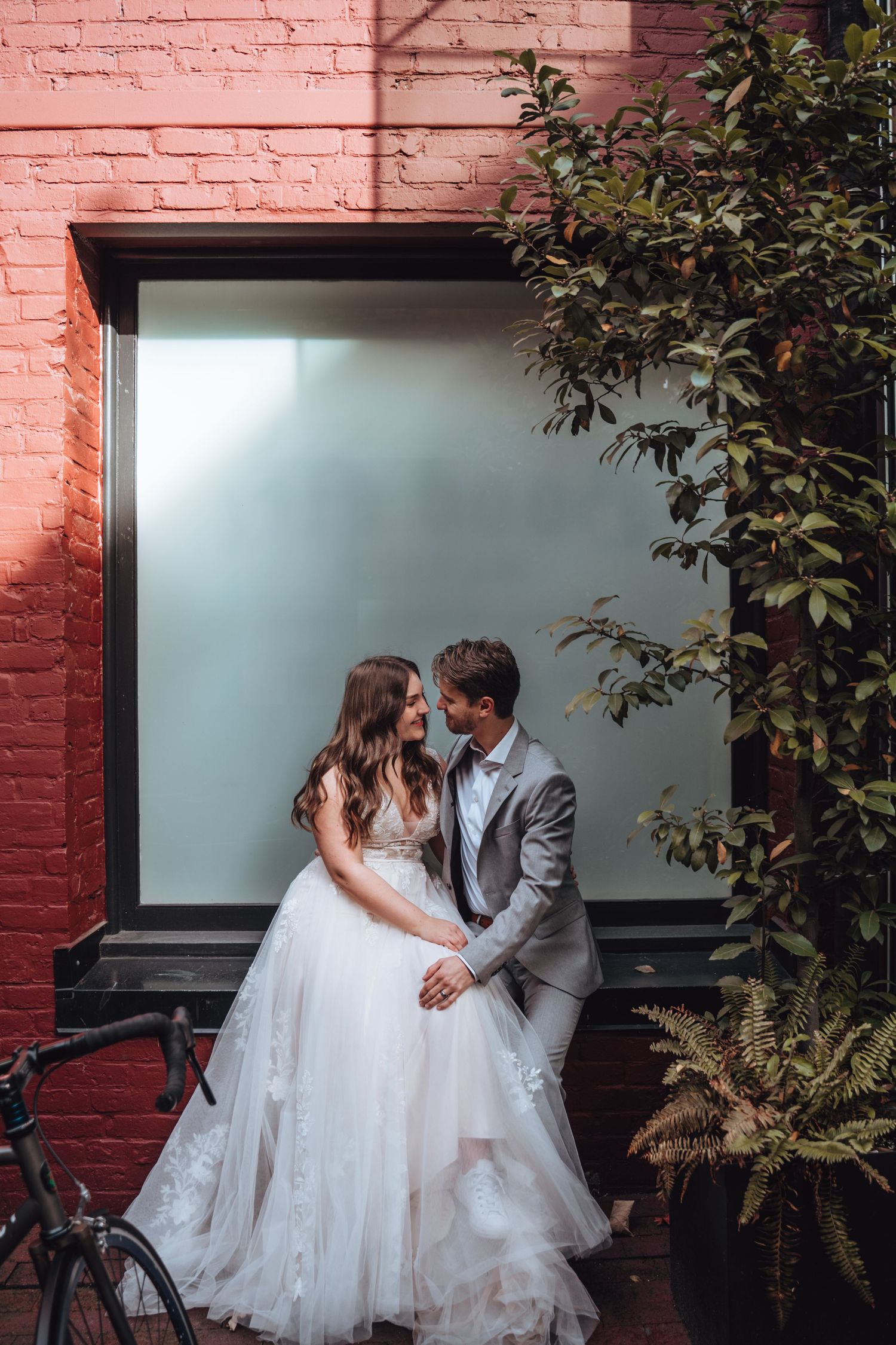 Bride and groom pose in the city. Vancouver wedding.