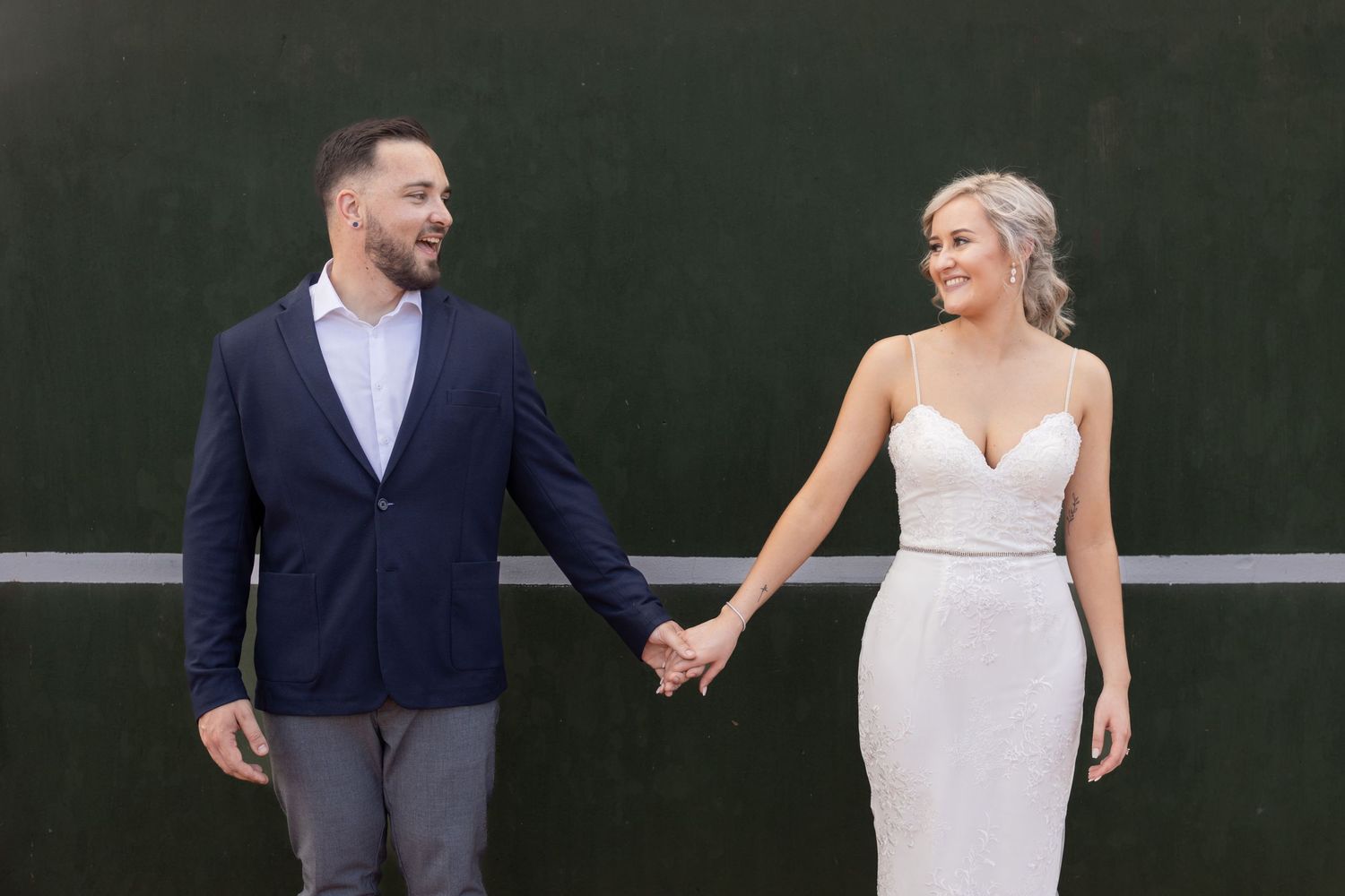 Bride and groom holding hands during engagement session in Centurion with natural, relaxed style and modern urban backdrop