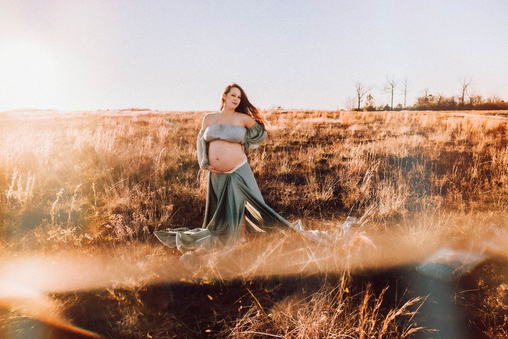 Dramatic poses captured in a natural setting with warm sunset lighting.