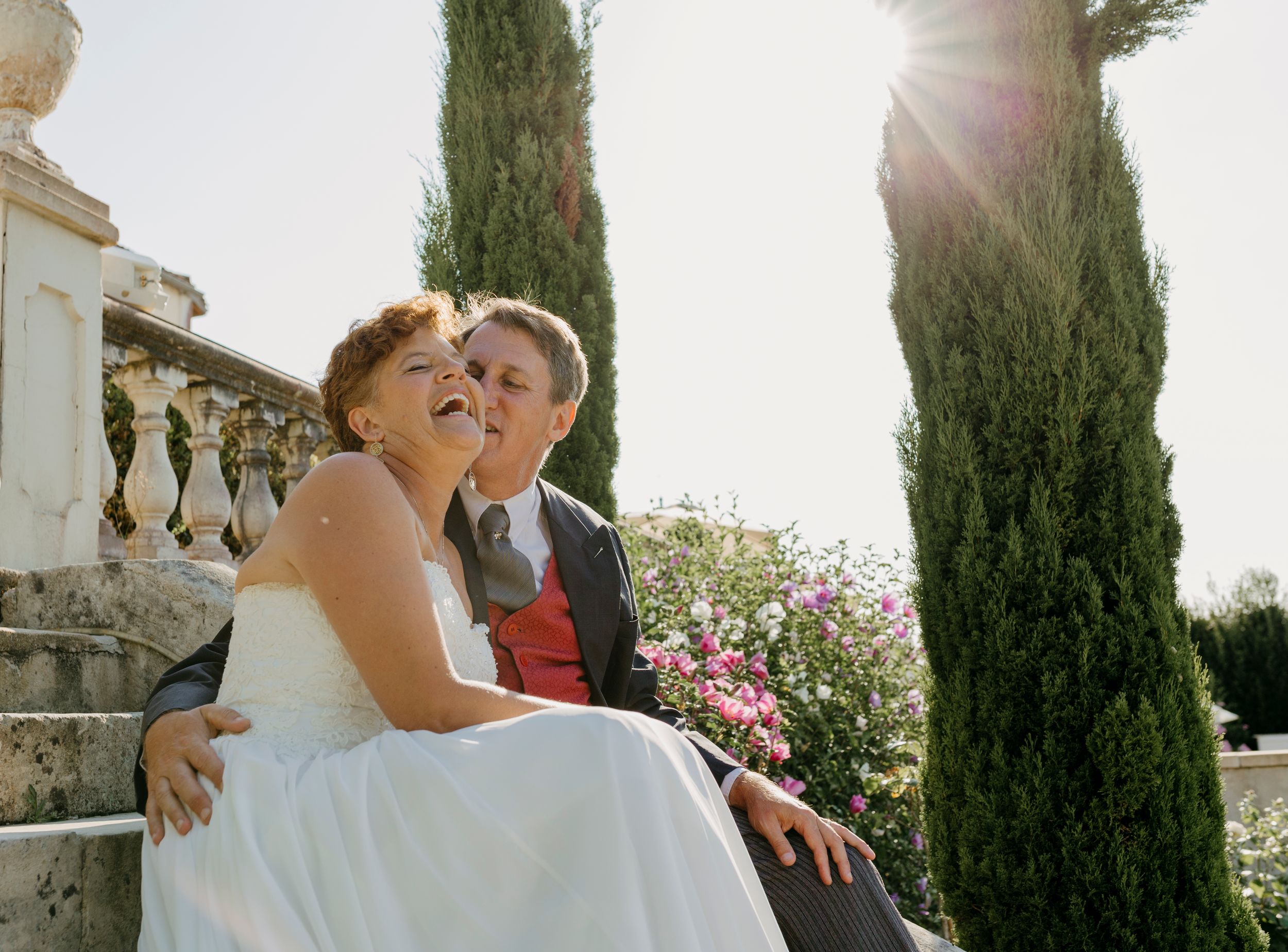 Romantic outdoor wedding moments captured against cypress trees and architecture.