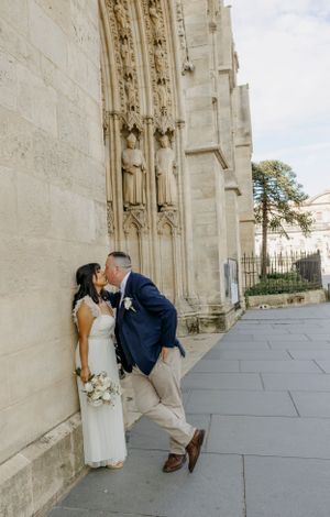 A romantic wedding photoshoot sequence against a stone cathedral wall with playful poses.
