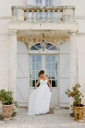 Artistic sequence of white shuttered windows against a classic French chateau facade.