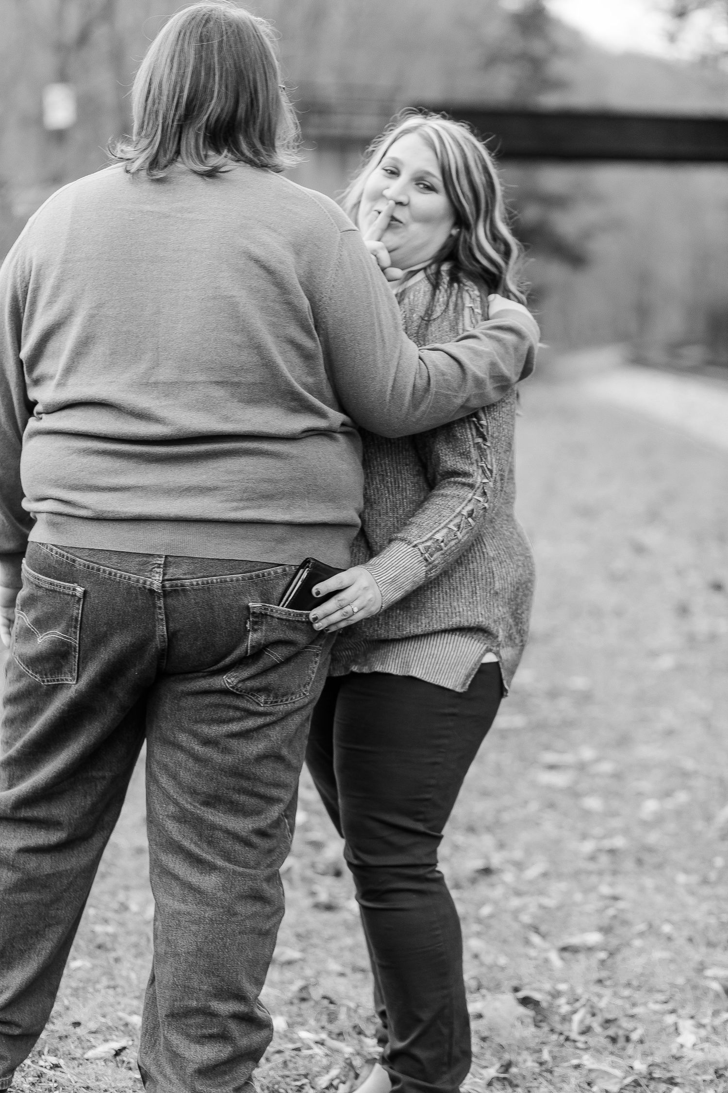 Black and white photo of two people embracing outdoors.