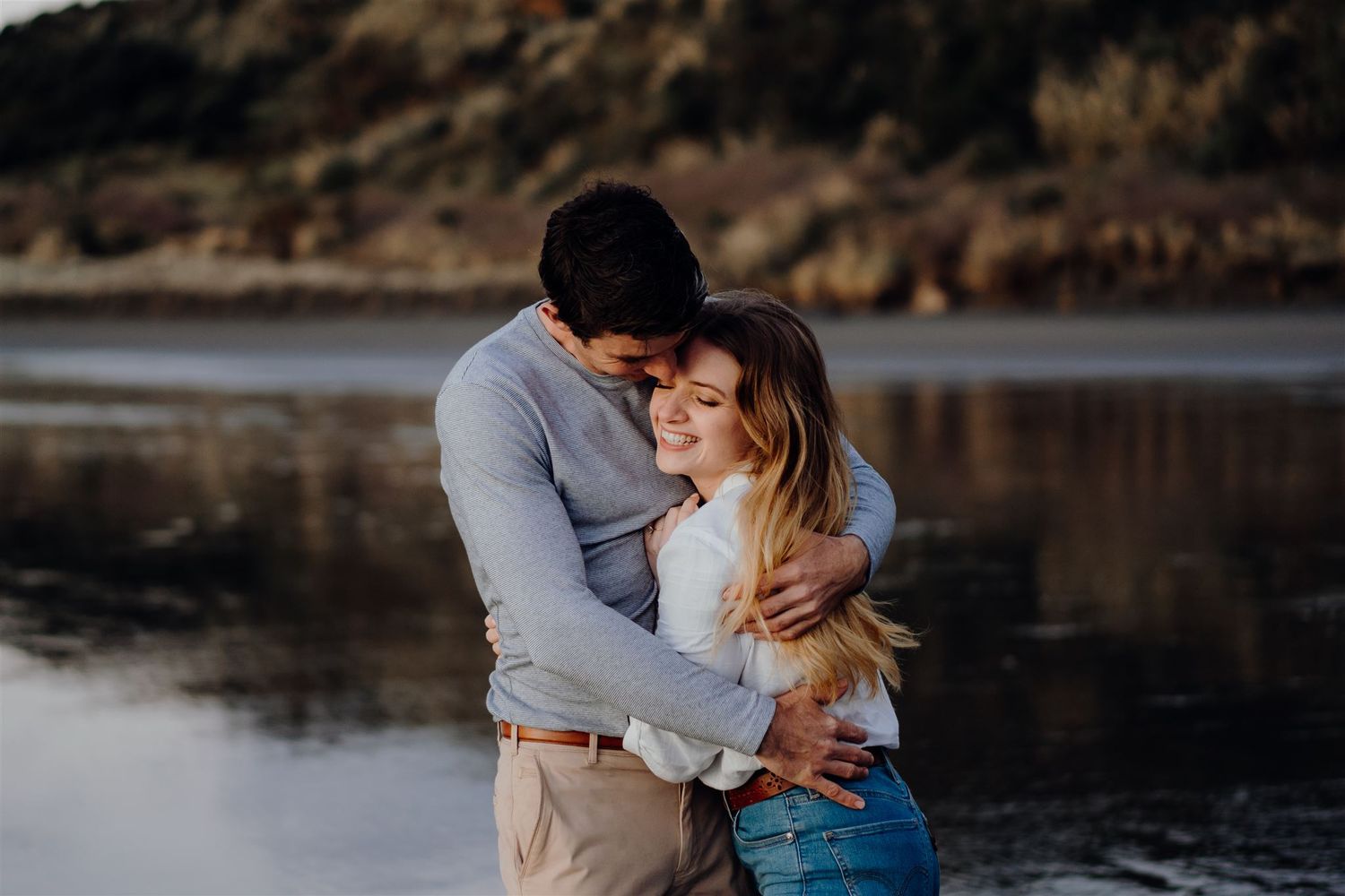 couple hugging at sunset on the beach
