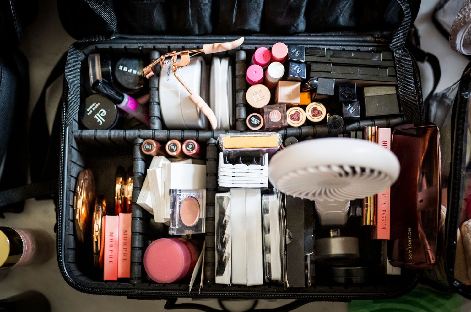 Close-up of professional makeup products and brushes arranged for wedding preparation.