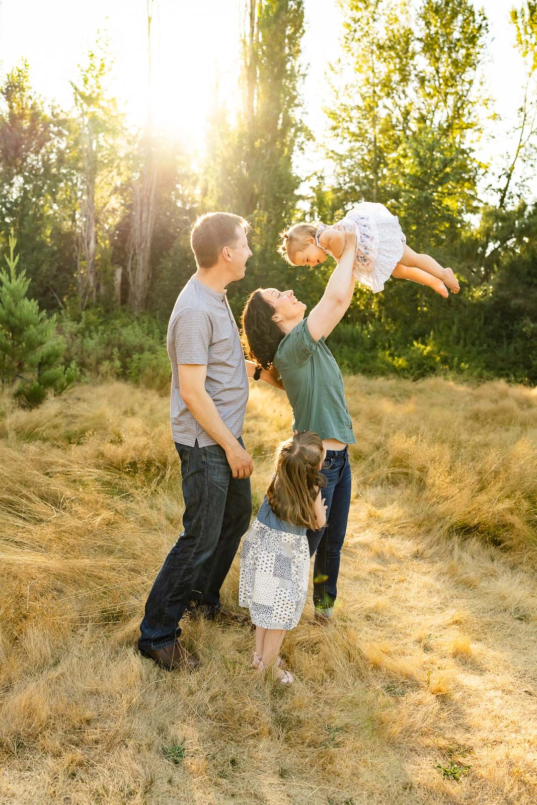 Lifestyle outdoor family photo in golden hour light.