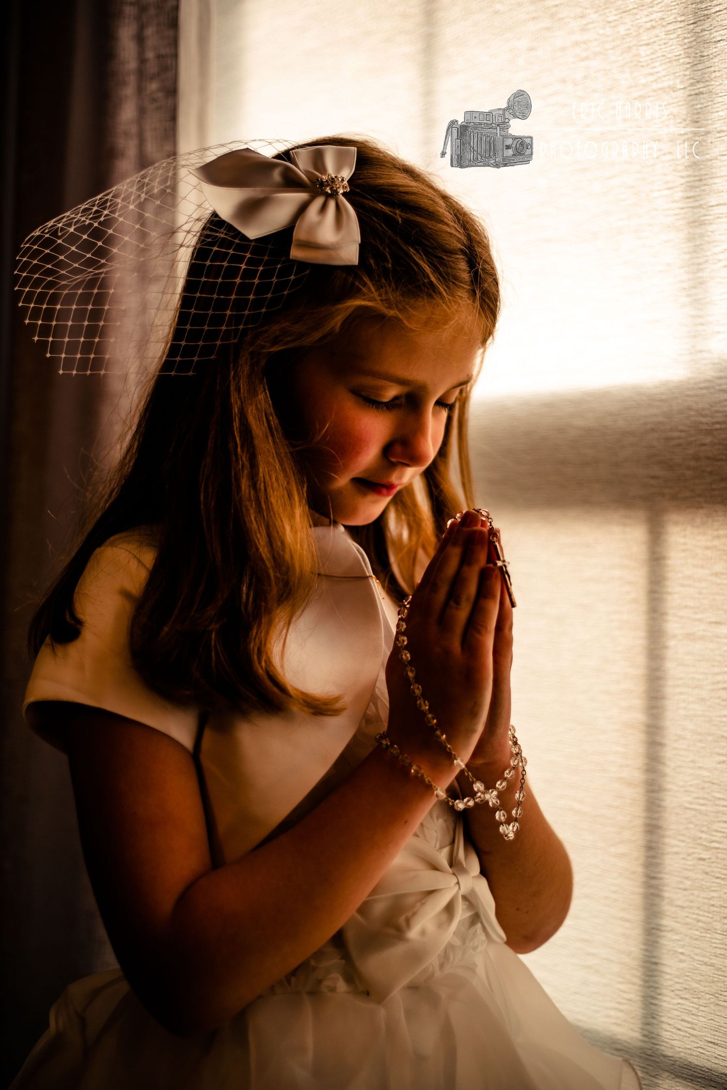 little girl indoors with prayer hands