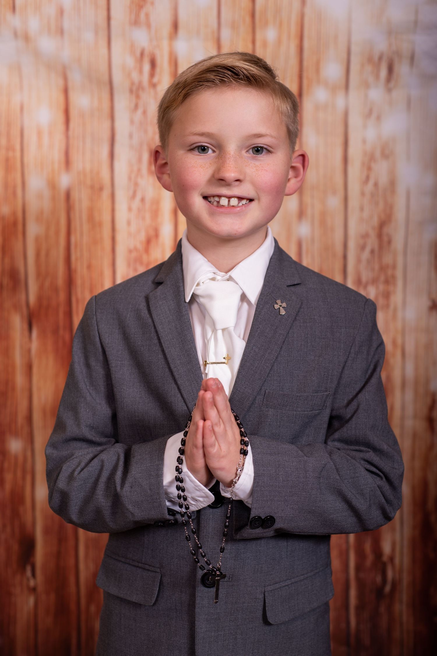 young boy with prayer hands for First Holy Communion