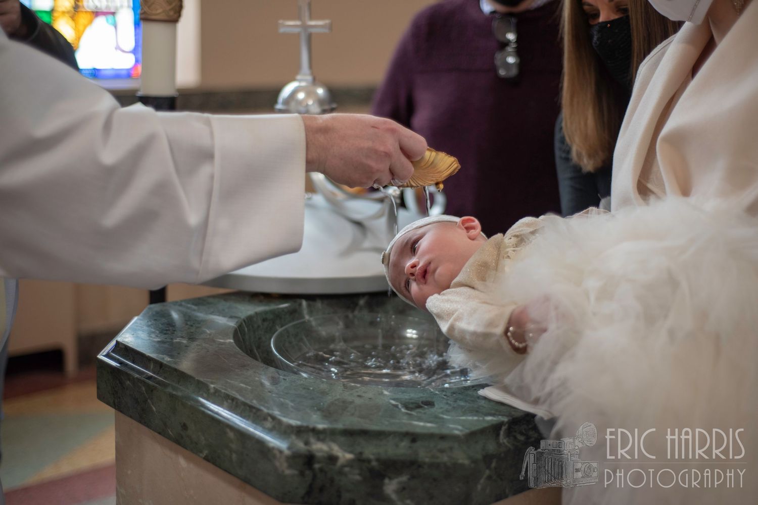 little girl having Holy Water poured on her at Christening