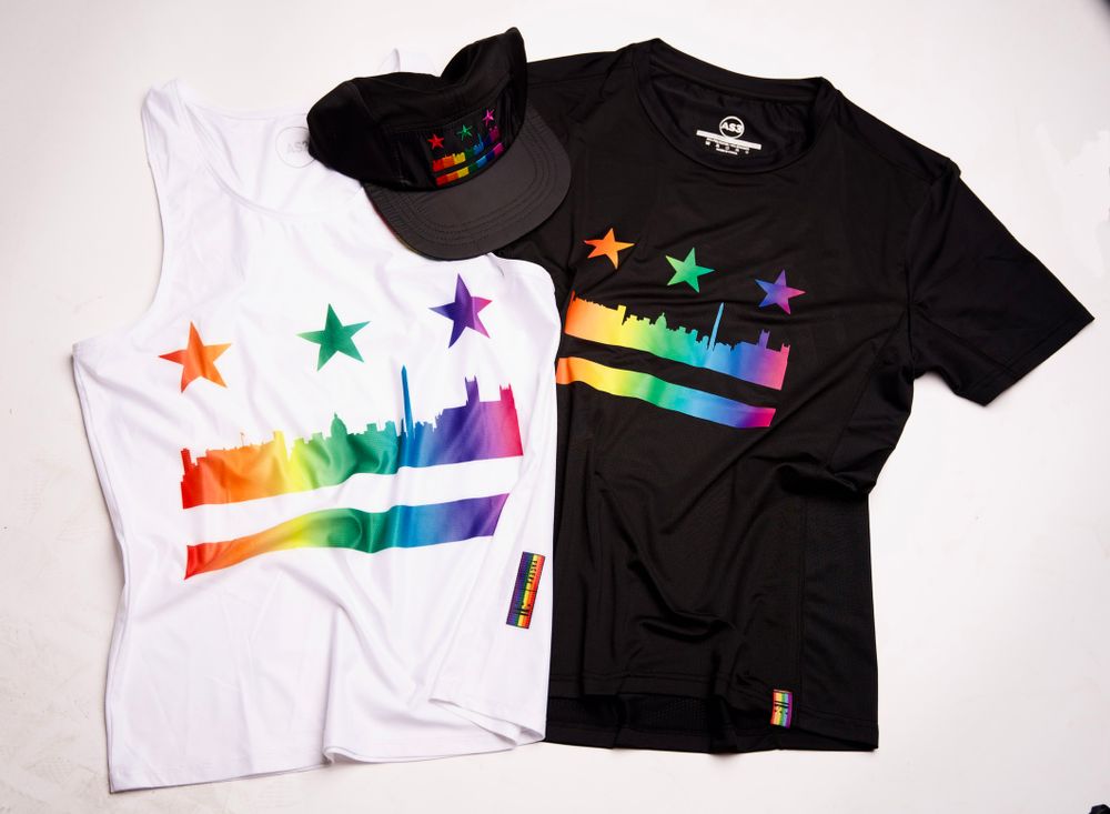Two t-shirts featuring rainbow city skyline design in black and white colorways.