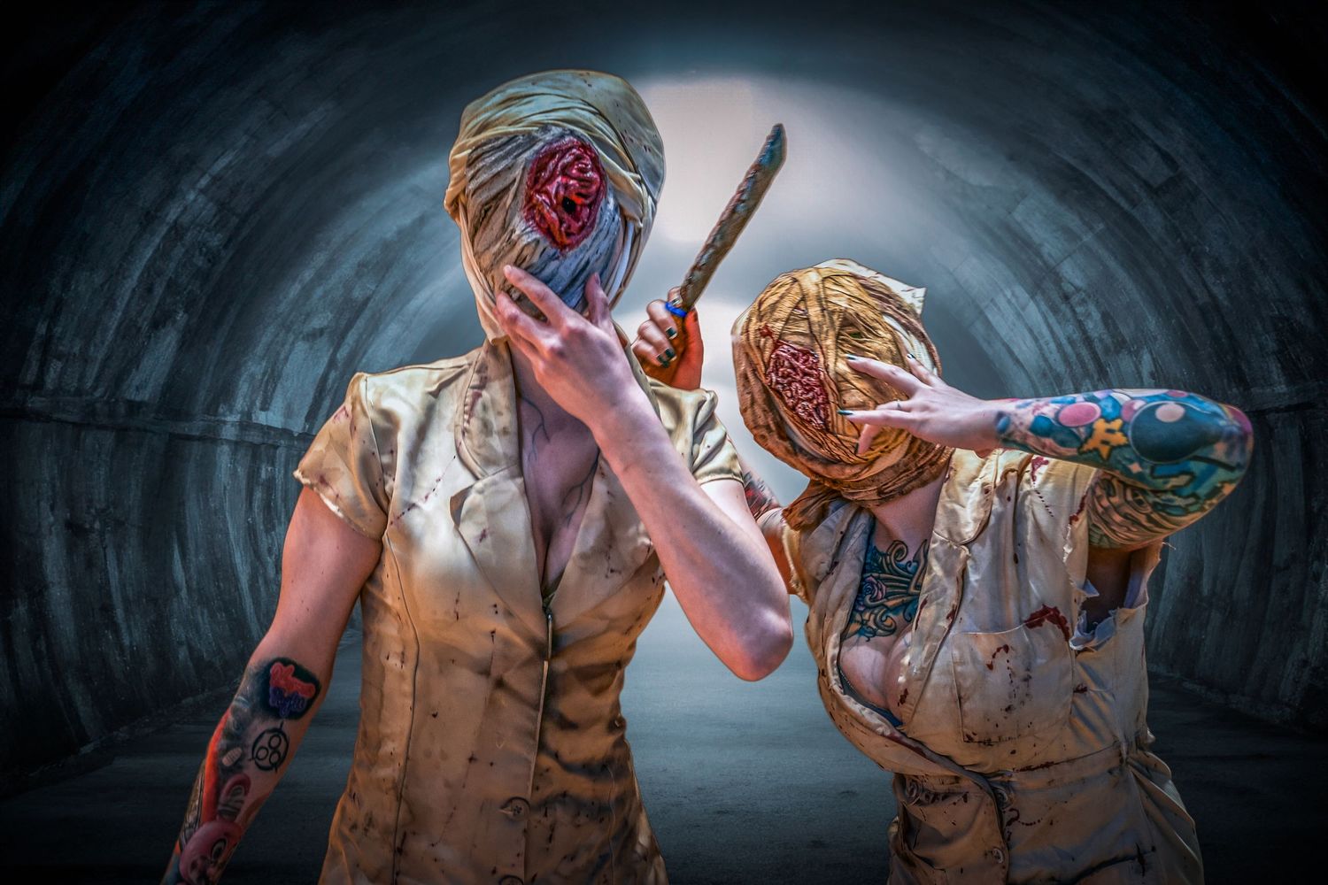 Two people in spooky masks and vests posing in dark tunnel setting.
