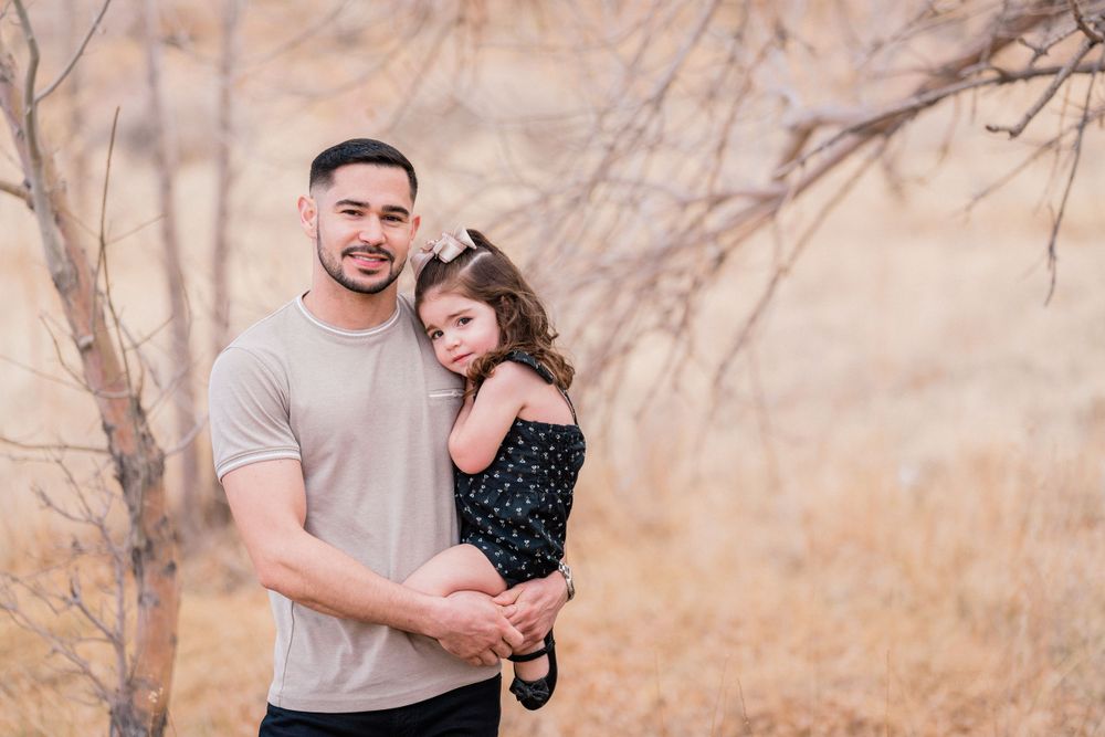 A heartwarming portrait of a parent and child against a natural desert landscape.