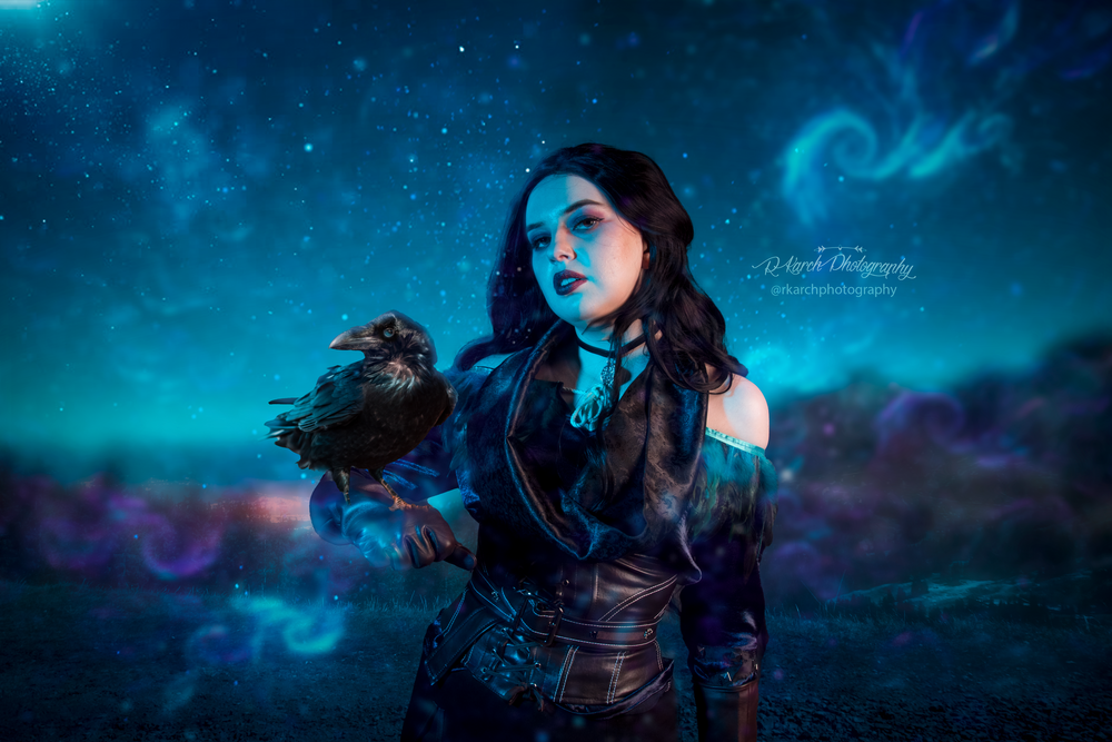 Dark fantasy portrait with ethereal blue lighting and gothic costume against a mystical night sky.