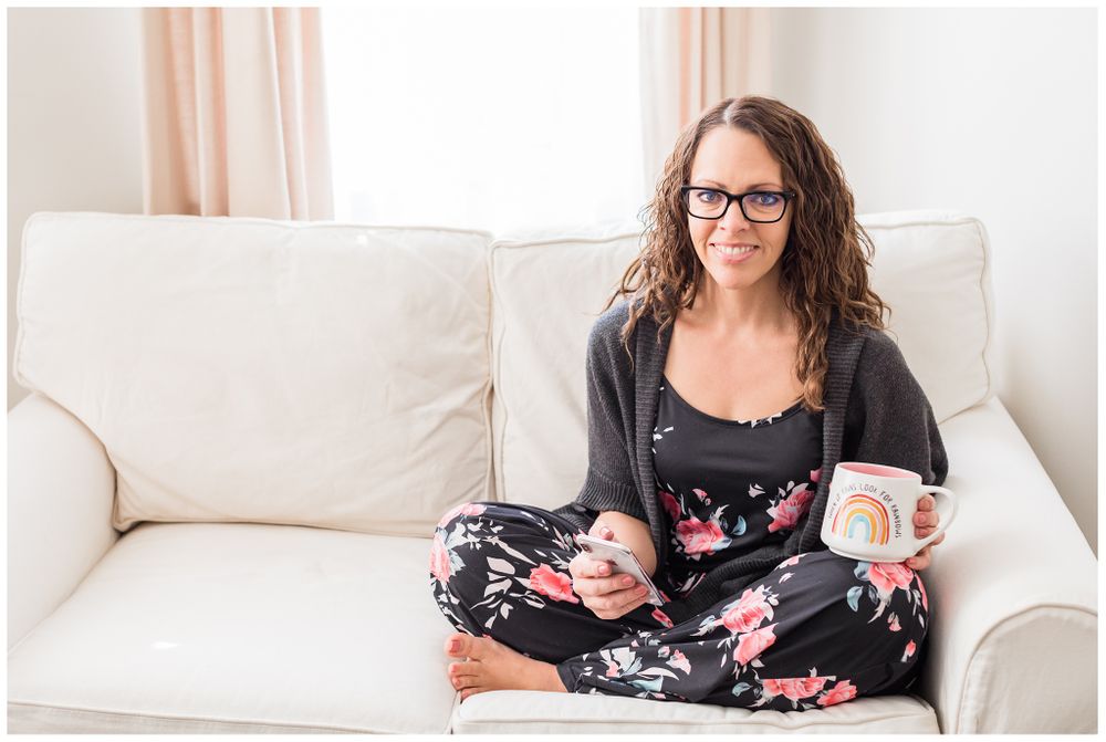 Woman drinking coffee on couch for brand session