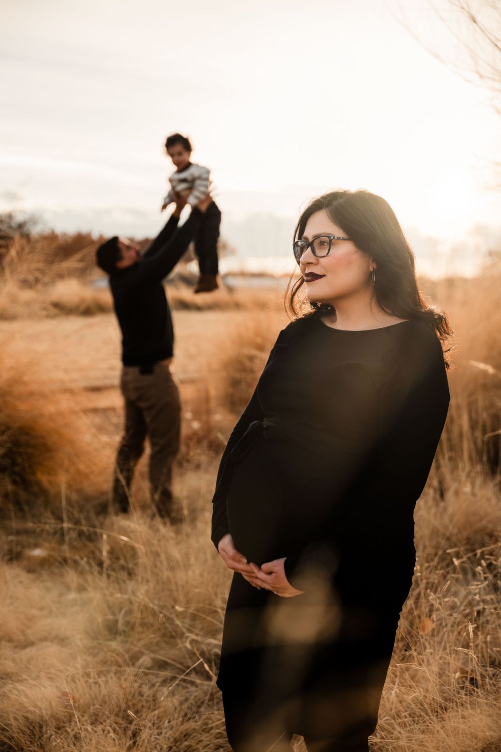 Artistic family portraits in warm sepia tones with desert brush backdrop.