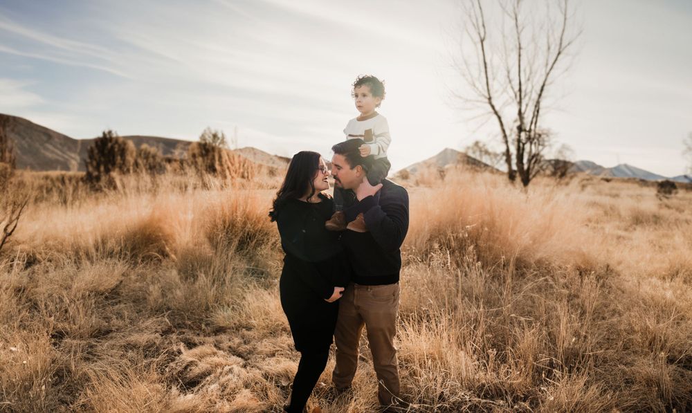Candid family moments captured in desert landscape during golden hour.
