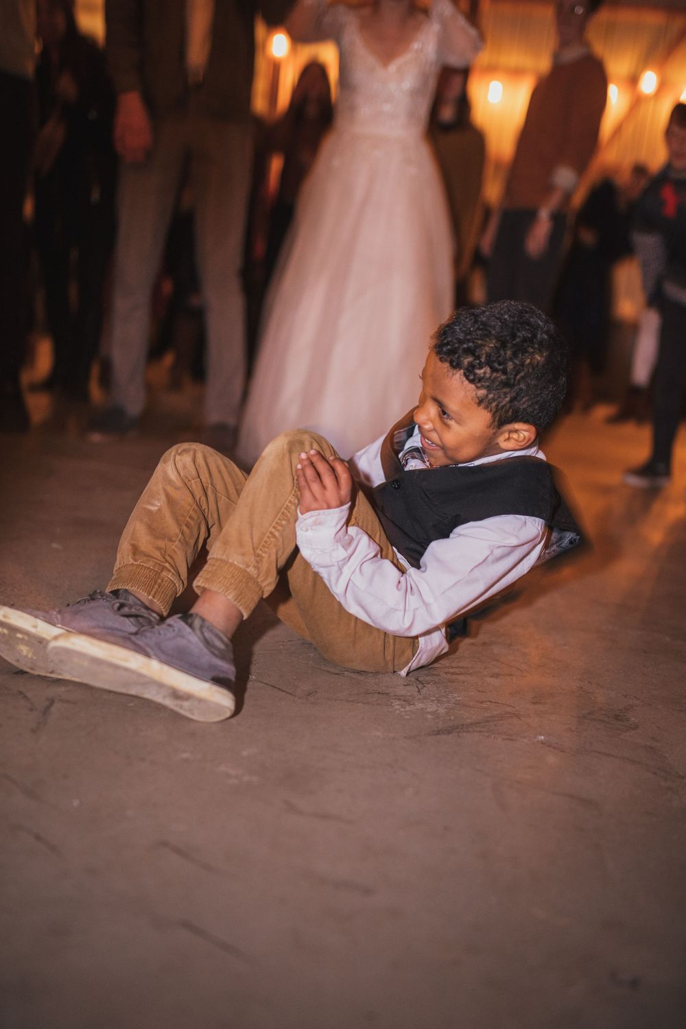 Wedding guests perform a fun choreographed dance routine lying on the reception floor.