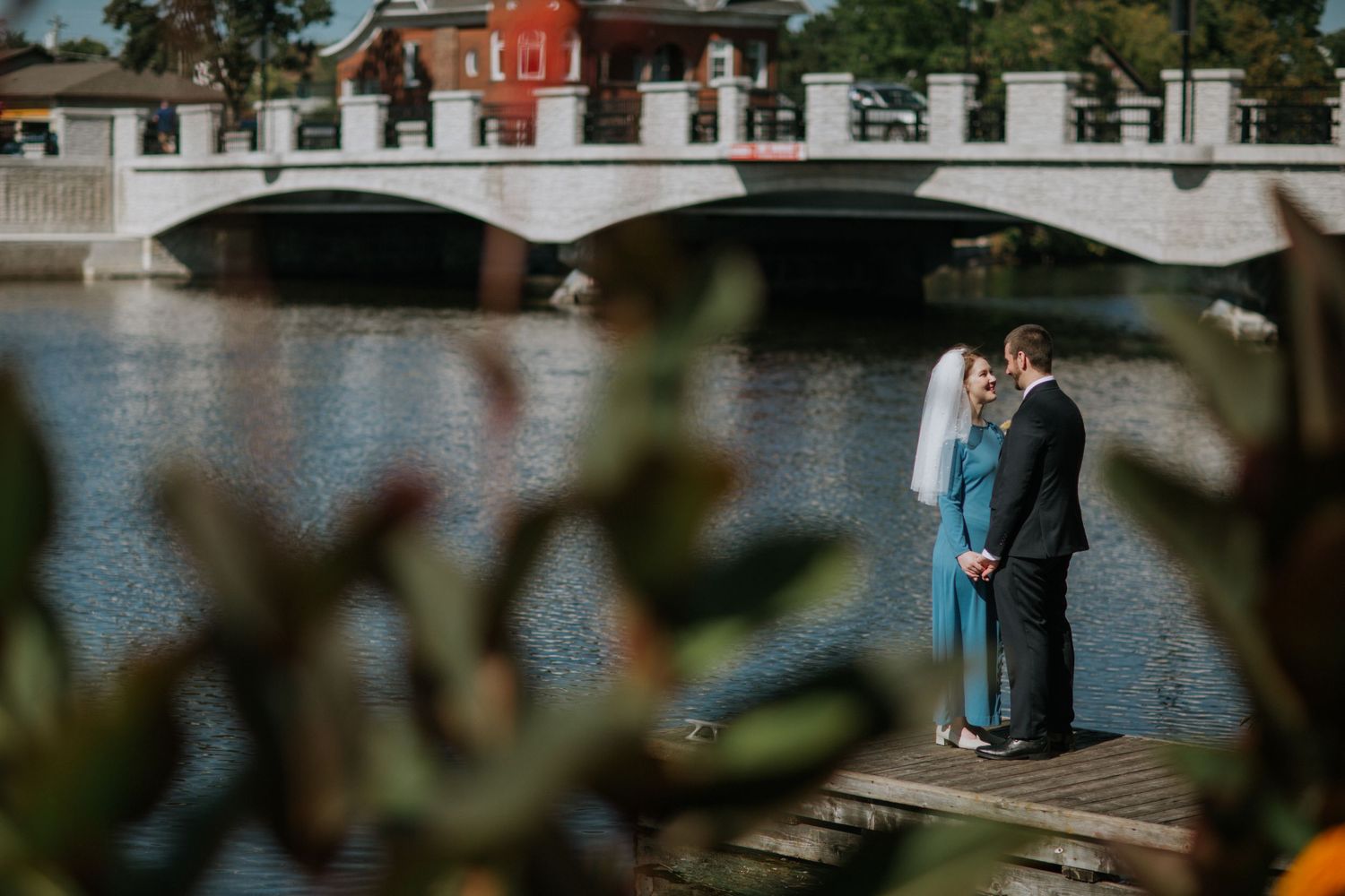 Waterfront venue with classic red building and white trim on a sunny day.