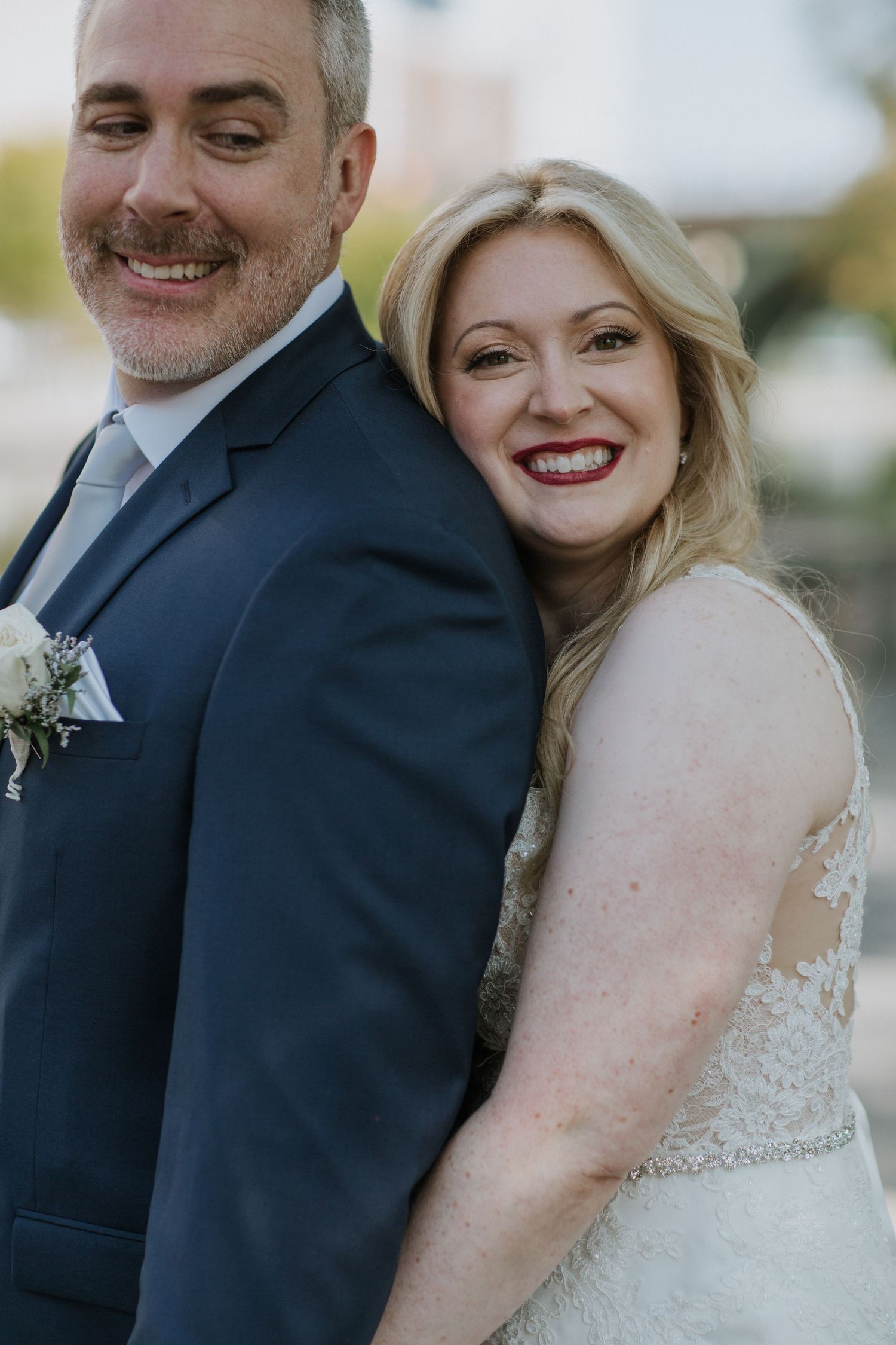 A happy couple shares a joyful moment on their wedding day.