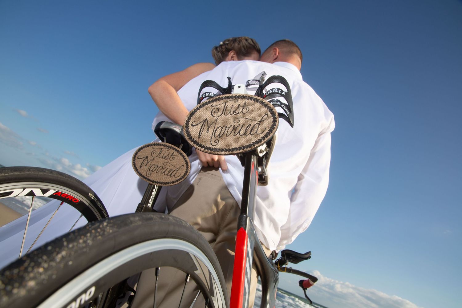 Close-up of bicycle handlebars against blue sky background.