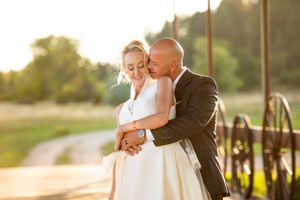 Romantic sunset wedding portraits captured in golden hour lighting.