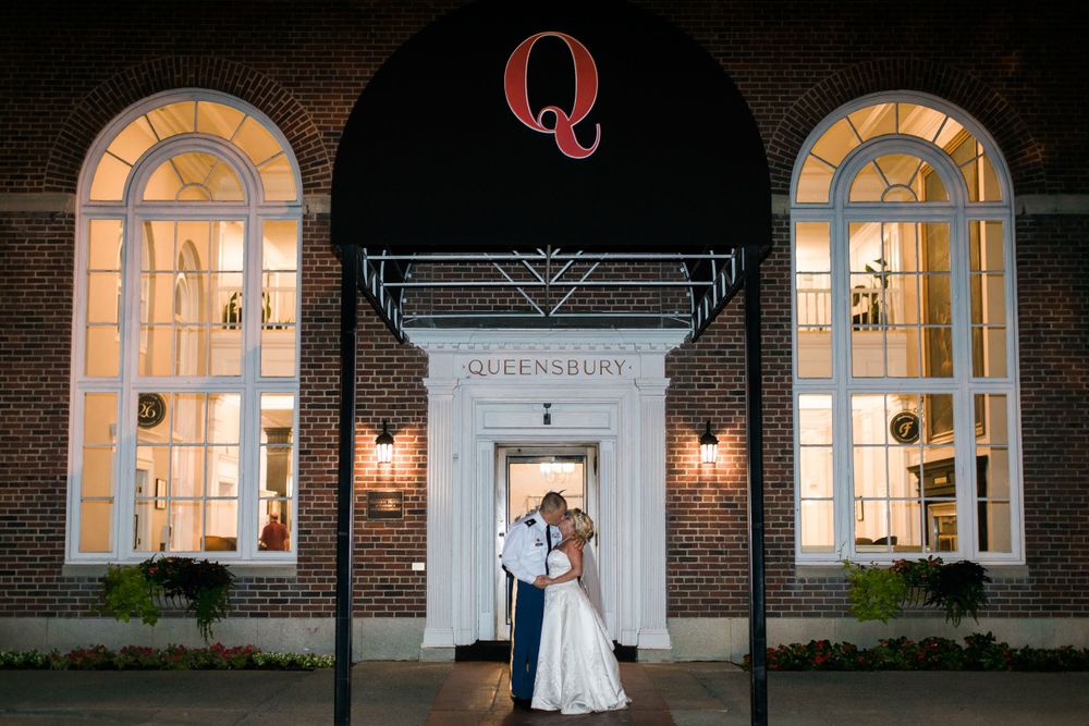 Elegant brick venue entrance with illuminated arched windows and Q signage at The Queensbury.