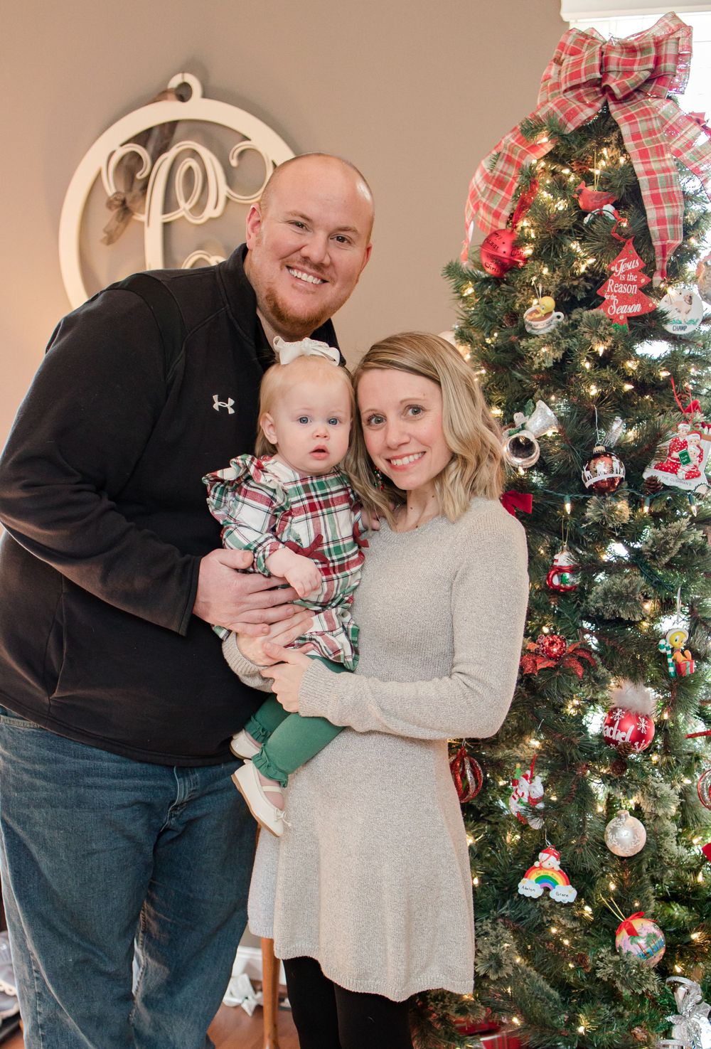 family standing by christmas tree