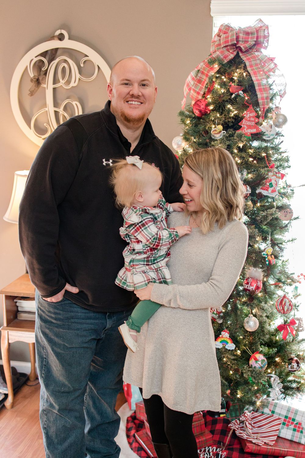 family standing by christmas tree