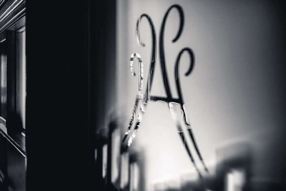 Black and white artistic photo of ornate metal decorative elements casting shadows.