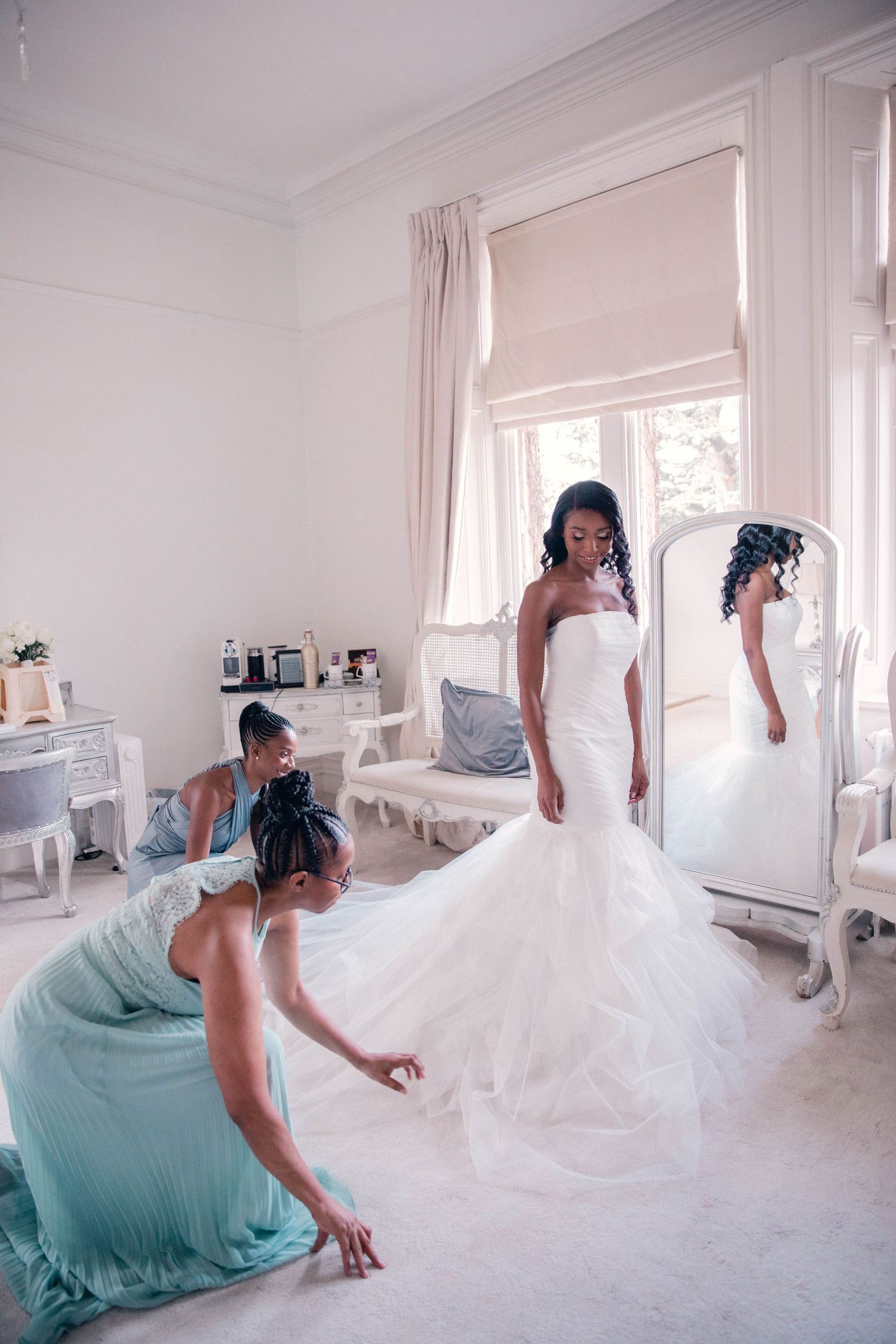Wedding dress preparation sequence in bright white dressing room.