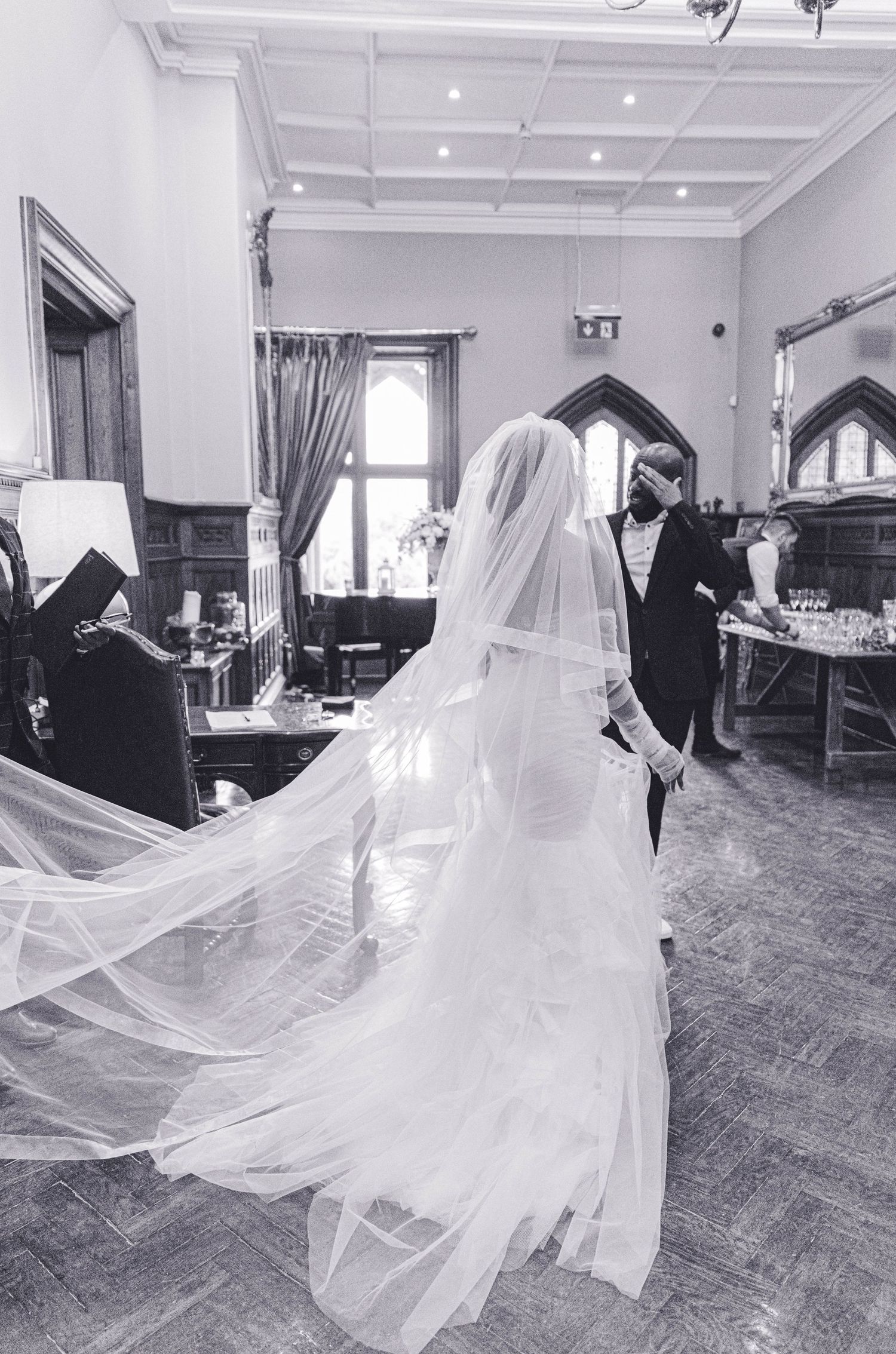 Dramatic black and white shots of flowing wedding dress train in motion.