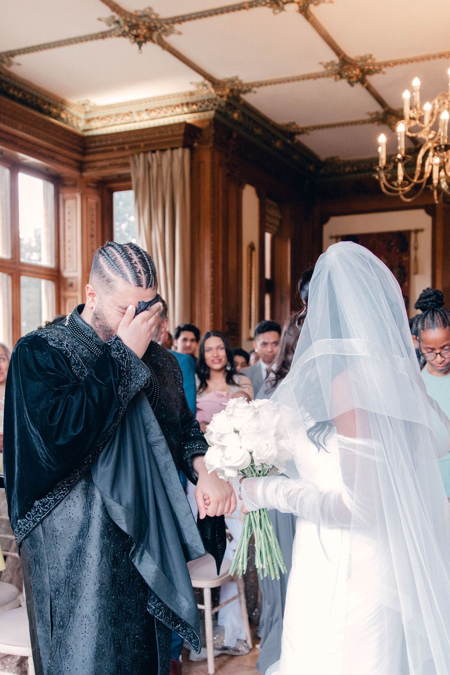 Candid moments during wedding reception in an elegant wood-paneled venue.