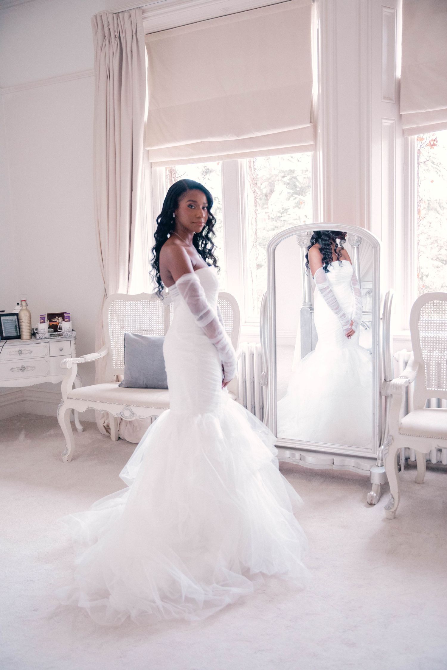 Elegant bridal photoshoot sequence showing flowing white wedding dress in a bright room.