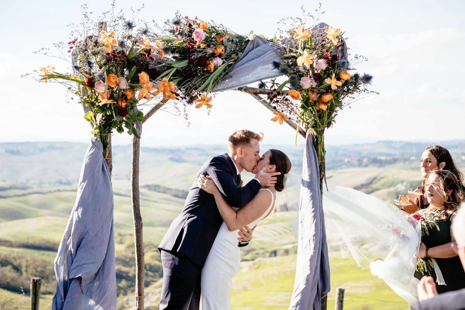 First kiss between the bride and groom at their dream wedding ceremony held at the Lazy Olive, Tuscany.