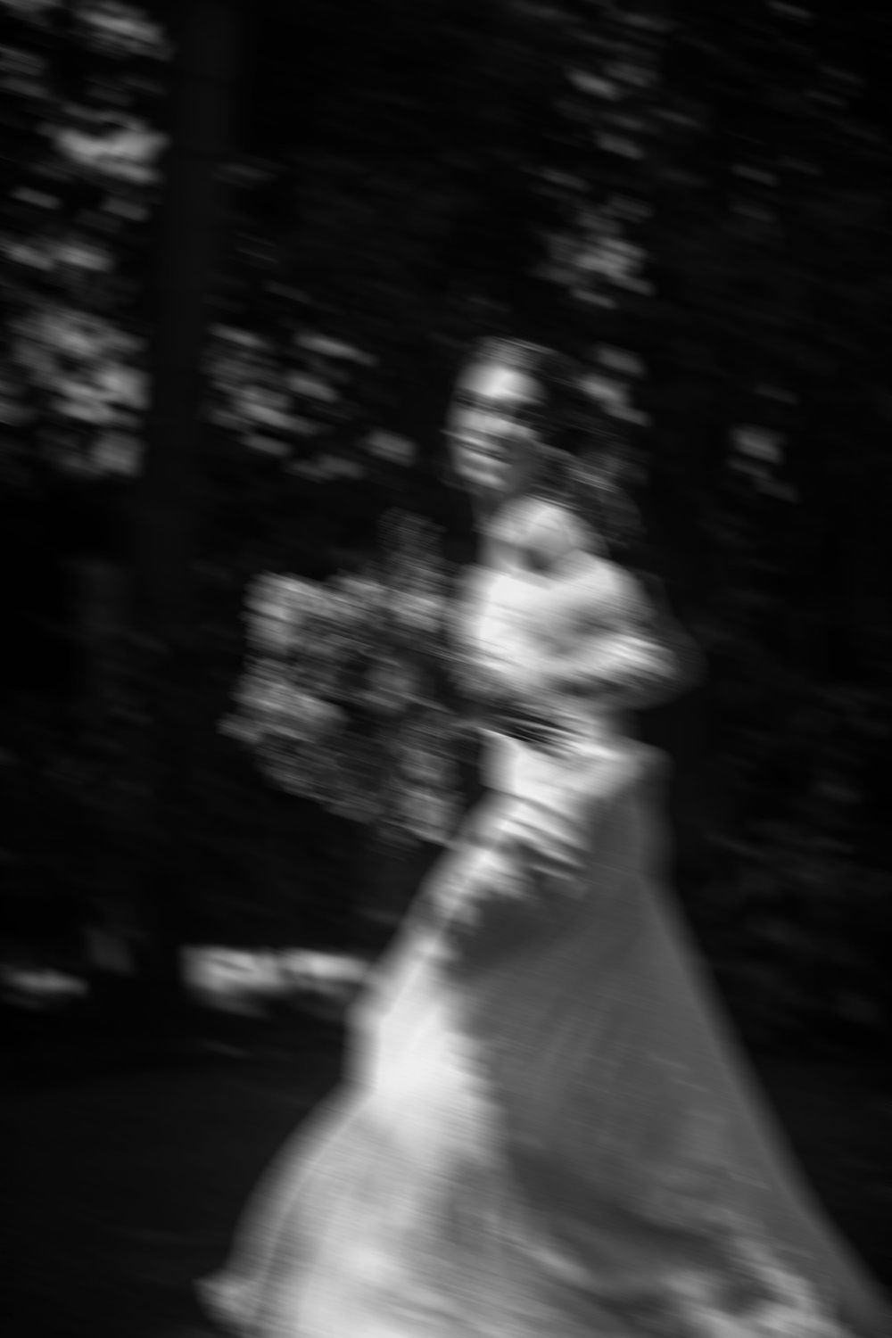 Artistic black and white wedding moment with motion blur, emotional wedding photography