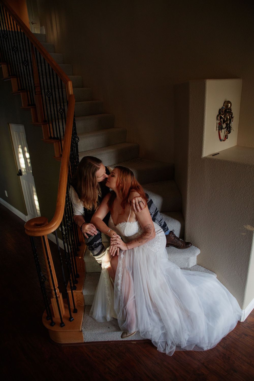 Intimate indoor wedding moment on staircase, storytelling wedding photography
