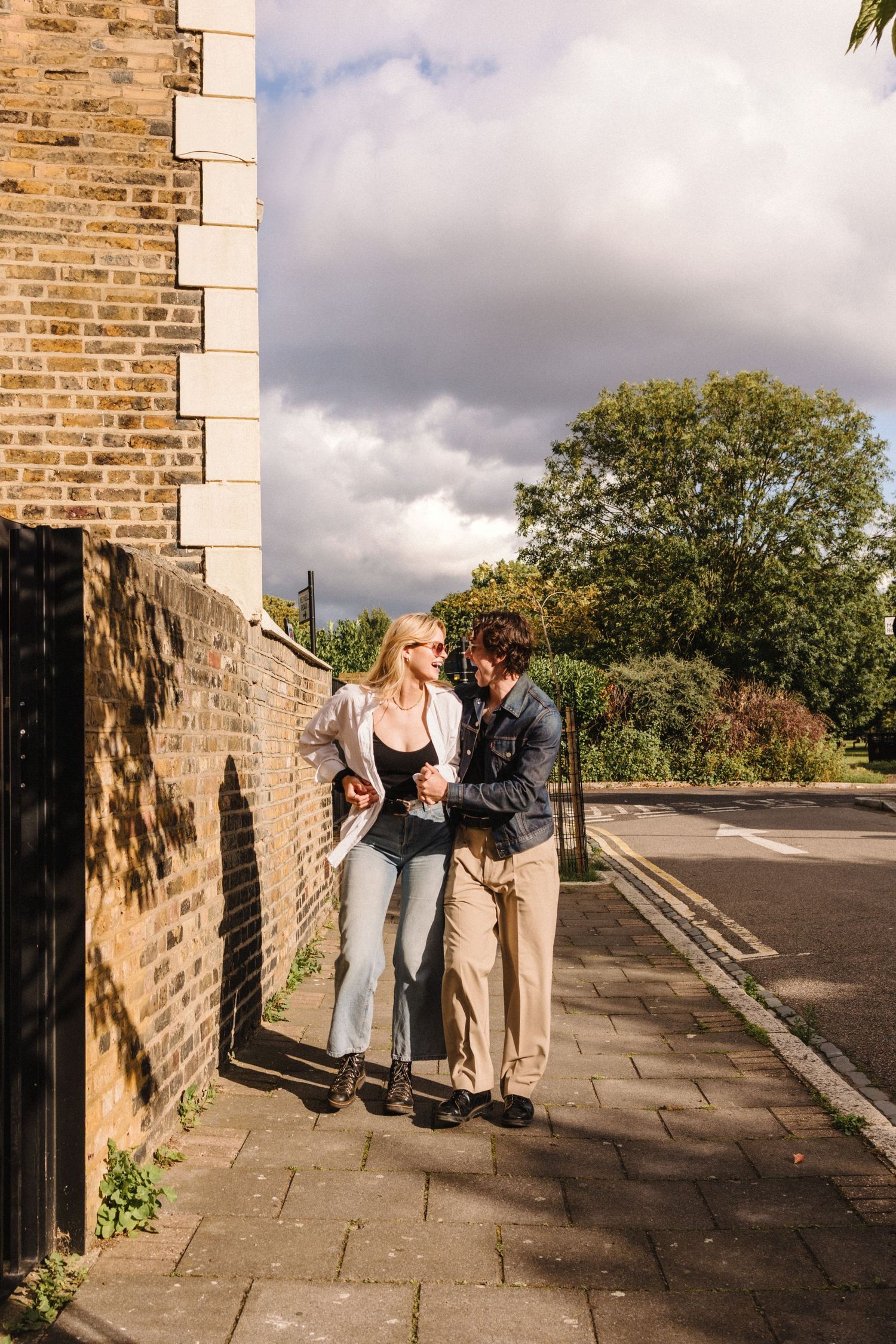 couple laughing walking down street