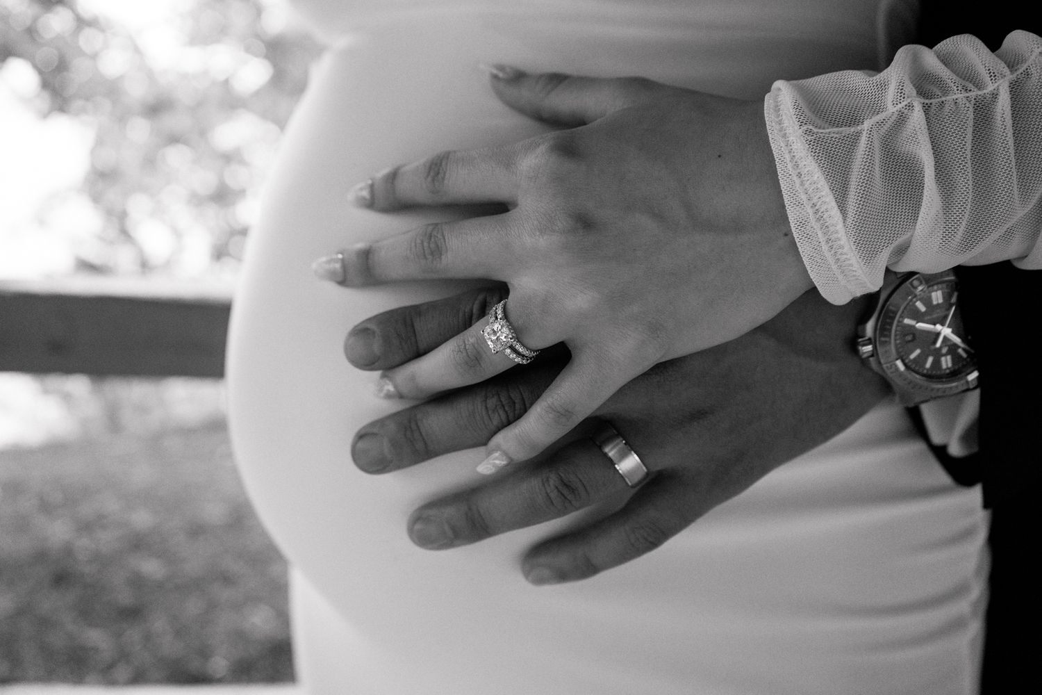 Close-up shots of wedding rings and hands against a natural background.