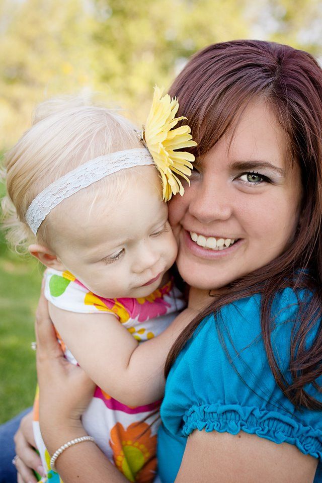 A cheerful moment captured outdoors with a yellow flower accent on a sunny day.