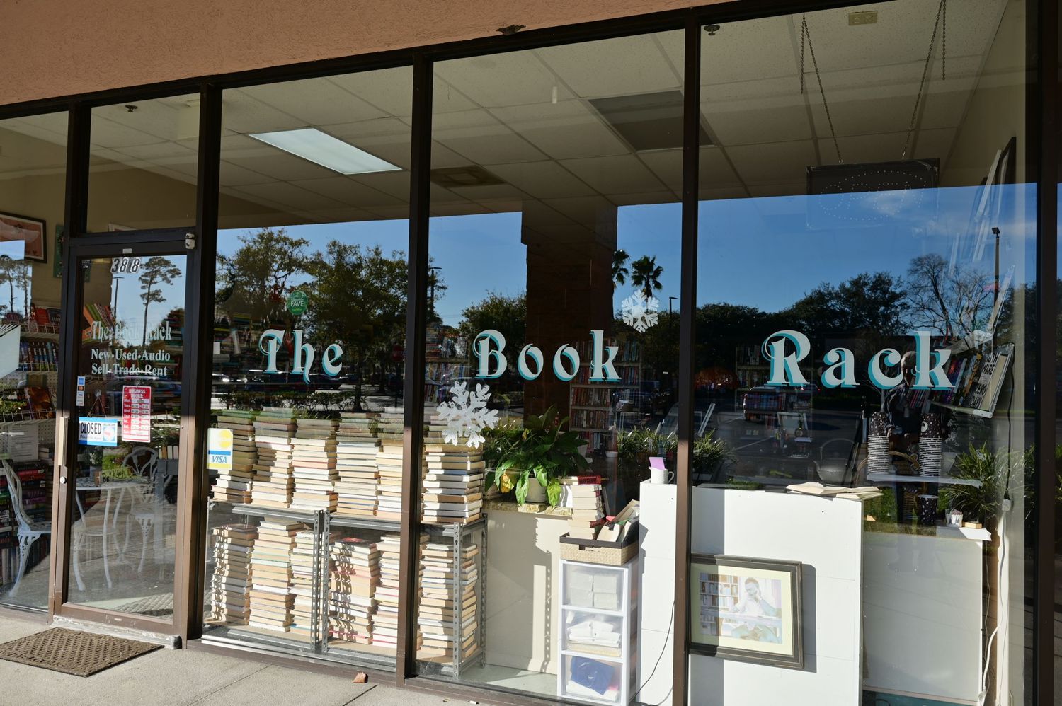 Exterior of The Book Rack bookstore with vintage-style lettering on glass storefront windows.
